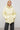 Pale yellow insulated quilted jacket with drawstring