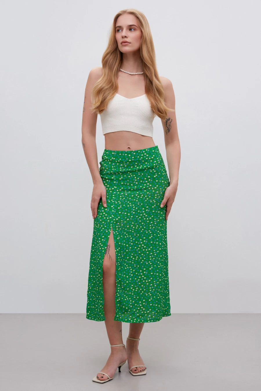 Green midi skirt with a cut in the print "white flowers" made of viscose