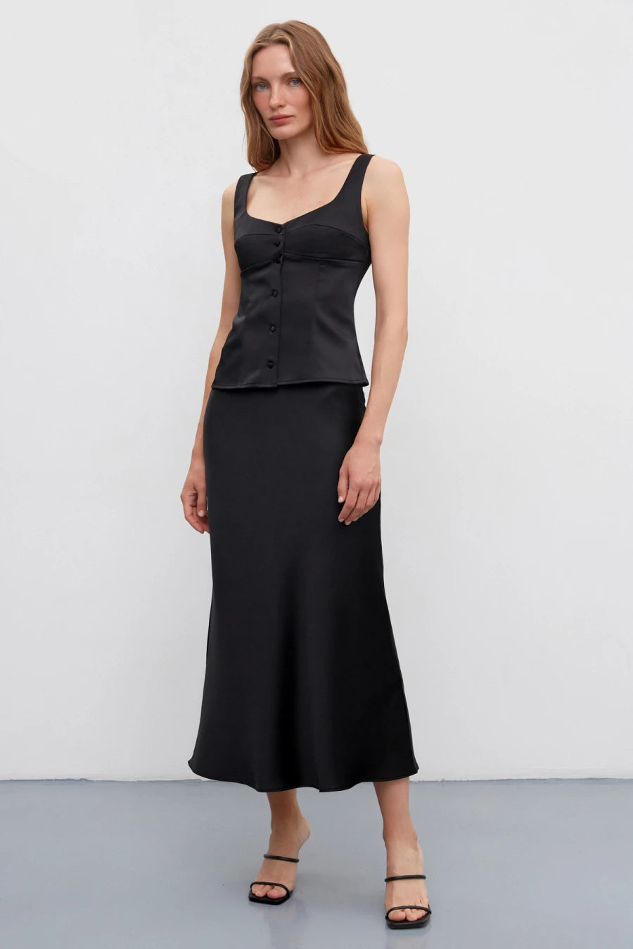 Black long midi skirt made of dense satin