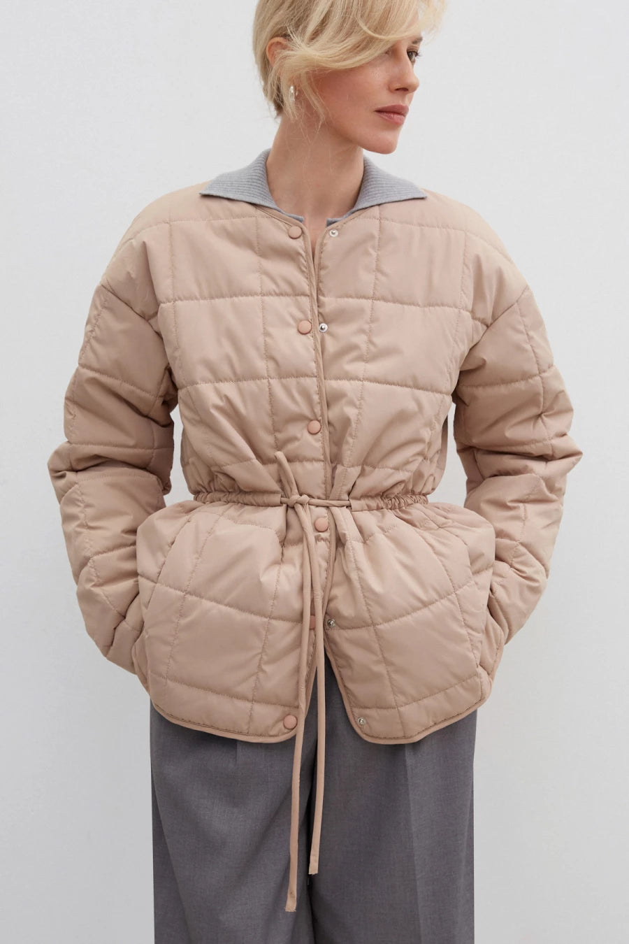 Beige quilted jacket with an accent waist