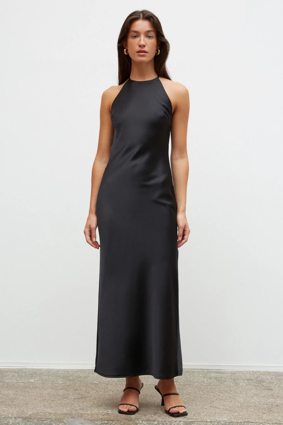 Black slip dress with an open back made of dense satin